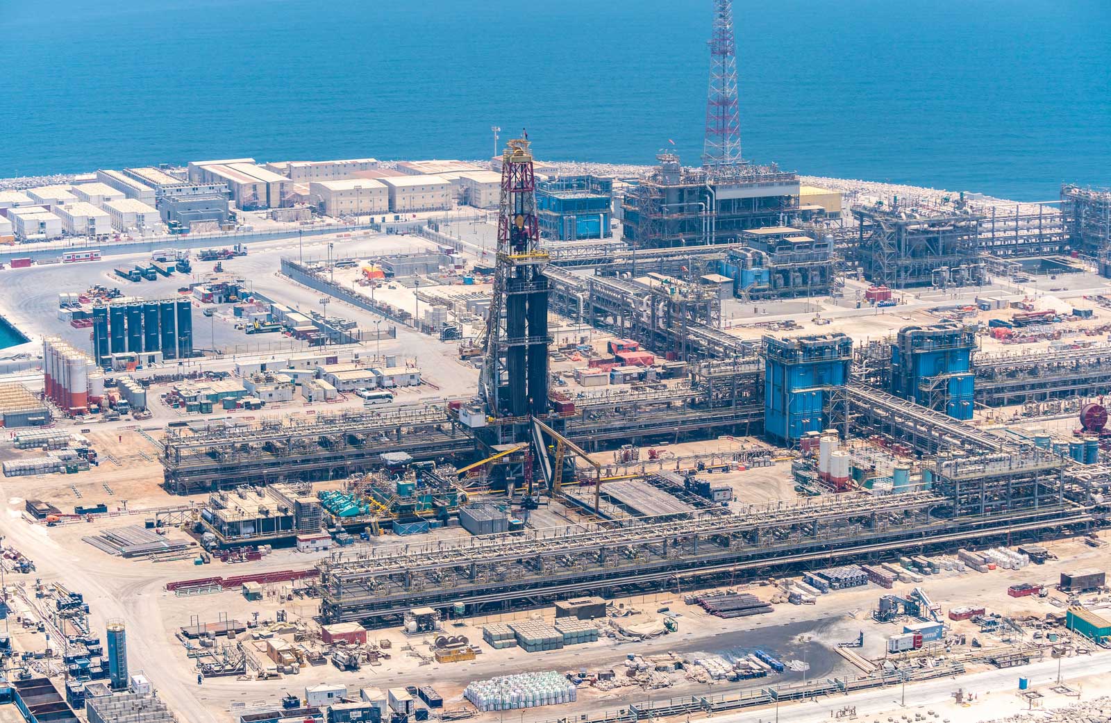 The image displays an aerial view of one of the artificial islands at the Upper Zakum oil field, located offshore Abu Dhabi in the United Arab Emirates. Upper Zakum is the second largest offshore oil field in the world. Artificial Islands Project: The field's development includes the construction of artificial islands, like the one shown, to facilitate oil production and minimize infrastructure. Production capacity: The partners aim was to increase the field's production capacity to one million barrels per day by 2024, a key part of Abu Dhabi's vision to boost oil production. Operator, ownership and tools: It is operated by ADNOC Offshore, on behalf of its shareholders ADNOC, ExxonMobil, and Inpex. Technological advancements: The development plan incorporates a unique combination of technologies to enhance oil recovery and optimize infrastructure.